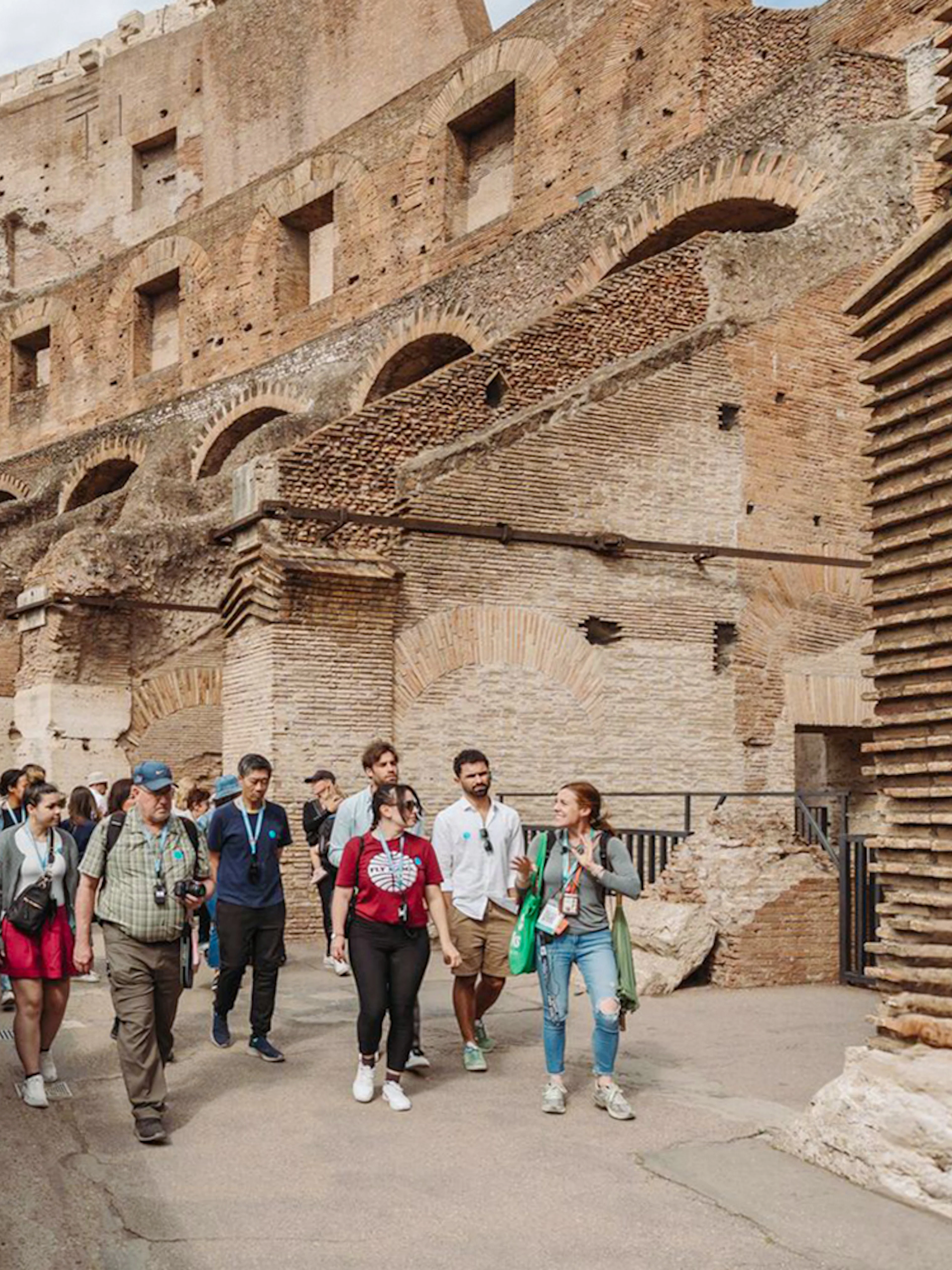 Tour group with guide exploring the Colosseum in Rome.