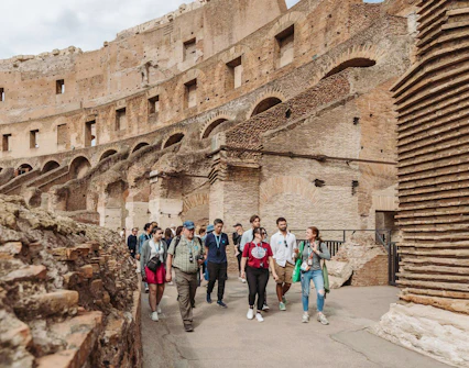 Tour group with guide exploring the Colosseum in Rome.