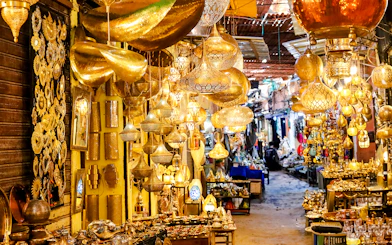 Marrakech souk with ornate golden lamps and vibrant market stalls.