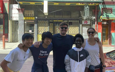 Group of people in front of a building in San Francisco Chinatown during a self-guided city exploration game.