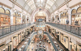 Queen Victoria Building interior with ornate architecture and central clock, Sydney.