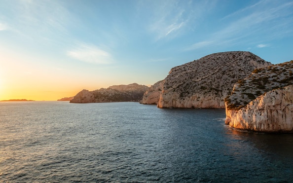 Marseille coastline at sunset during a dinner cruise.