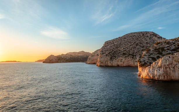 Marseille coastline at sunset during a dinner cruise.