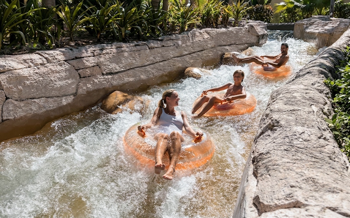 People enjoying a lazy river ride at Atlantis Aquaventure, Nassau, Bahamas.