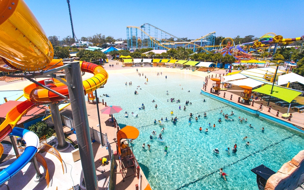 People enjoying wave pool and water slides at Whitewater World, Gold Coast.
