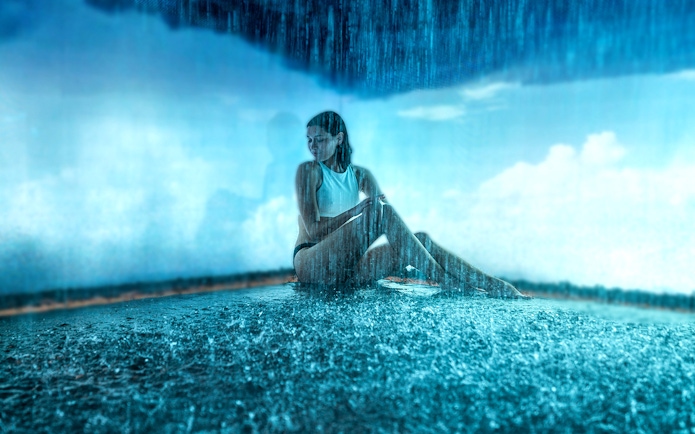 Visitor enjoying a rain shower at QC Terme Milano Resort & Spa.