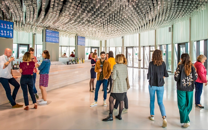 Visitors enjoying wine tasting at Cite du Vin's Belvedere in Bordeaux.