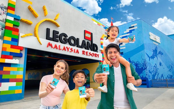 Family holding day passes at LEGOLAND Malaysia entrance.