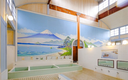 Public bath interior at Kotobuki-yu, Tokyo, featuring a mural of Mount Fuji.