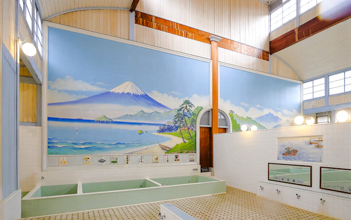 Public bath interior at Kotobuki-yu, Tokyo, featuring a mural of Mount Fuji.