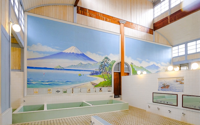 Public bath interior at Kotobuki-yu, Tokyo, featuring a mural of Mount Fuji.