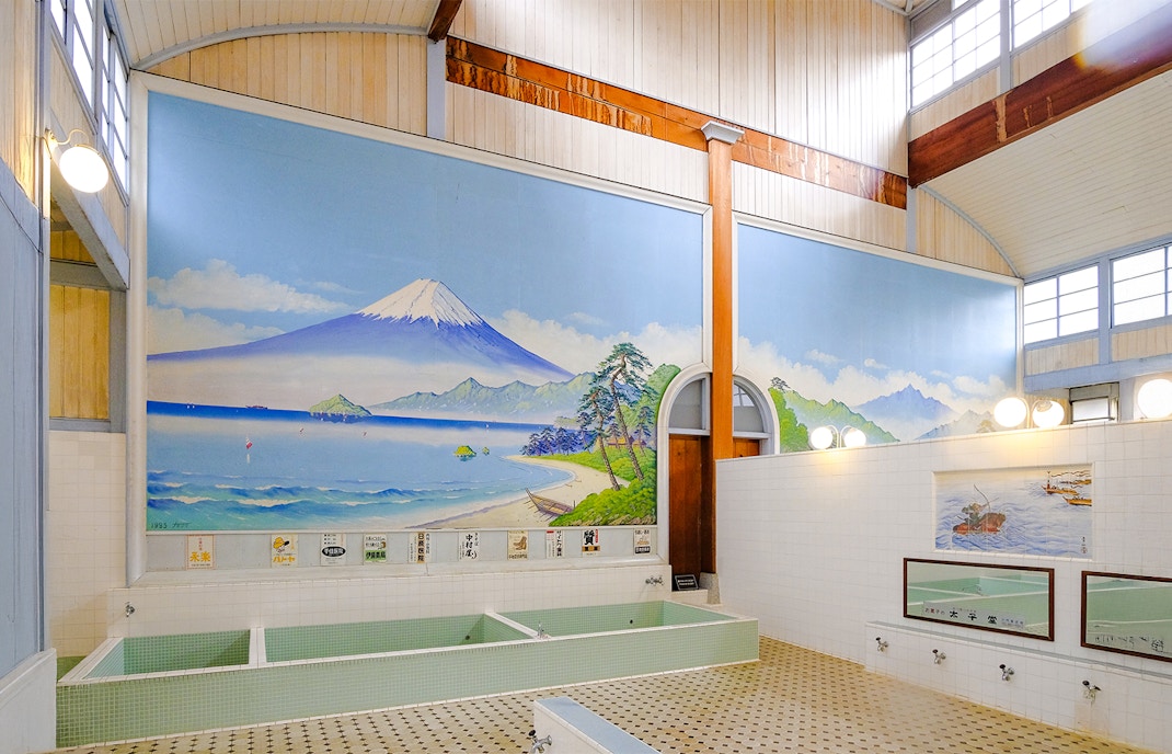 Public bath interior at Kotobuki-yu, Tokyo, featuring a mural of Mount Fuji.