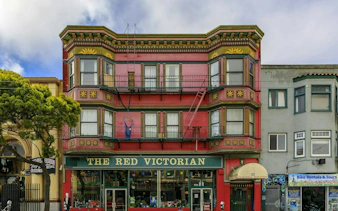 The Red Victorian building in Haight Ashbury, San Francisco, showcasing vibrant architecture.