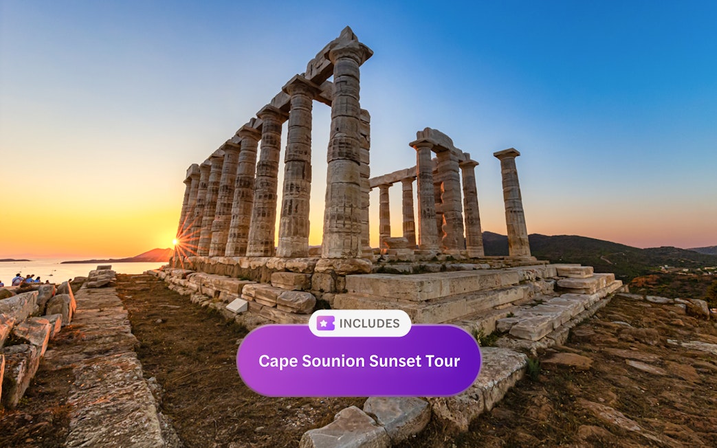 Sunset view at the Temple of Poseidon, Cape Sounion, with sea and hills in the background.