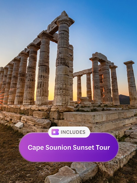 Sunset view at the Temple of Poseidon, Cape Sounion, with sea and hills in the background.