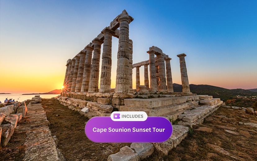 Sunset view at the Temple of Poseidon, Cape Sounion, with sea and hills in the background.