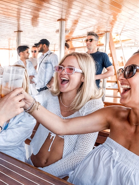 Guests toasting drinks on Split Party Cruise deck.