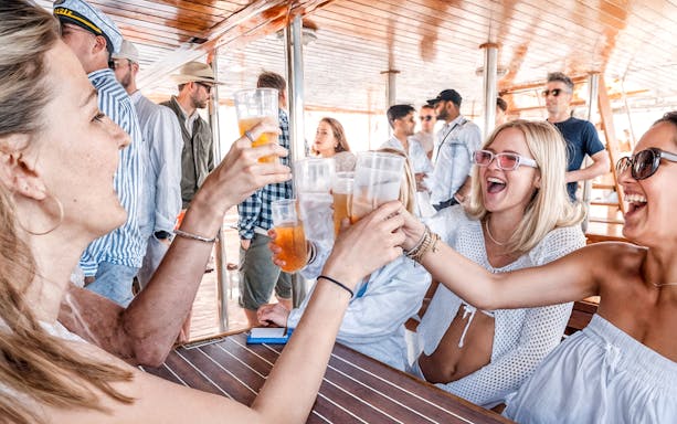 Guests toasting drinks on Split Party Cruise deck.