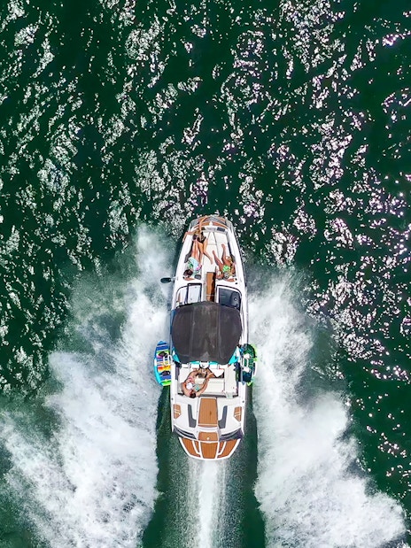Speed boat with people cruising on open water.