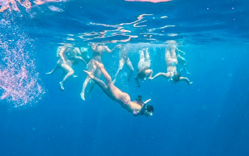 Snorkelers exploring underwater during a bay cruise from Larnaca.