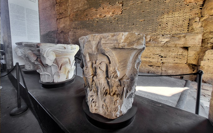 Colosseum museum artifact with carved stone capitals on display in Rome, Italy.