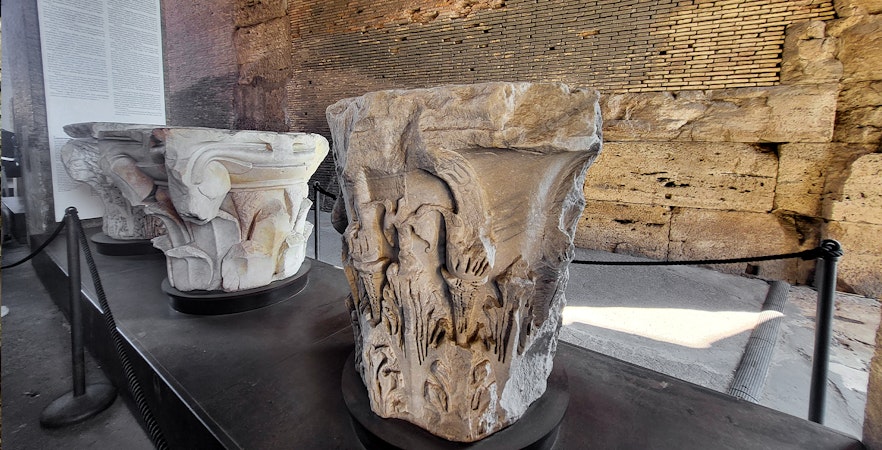 Colosseum museum artifact with carved stone capitals on display in Rome, Italy.