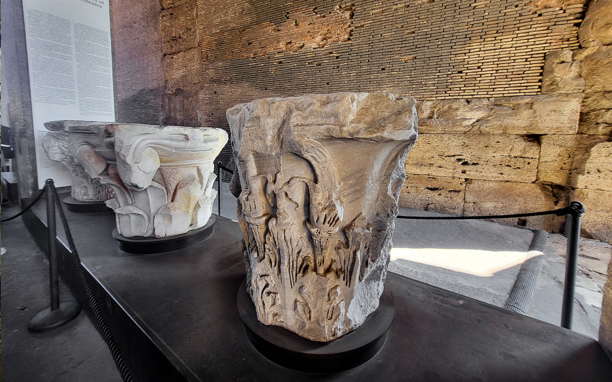 Colosseum museum artifact with carved stone capitals on display in Rome, Italy.