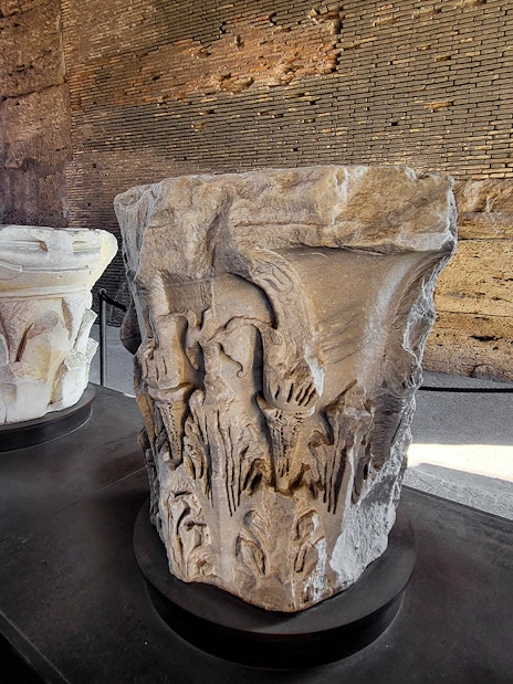 Colosseum museum artifact with carved stone capitals on display in Rome, Italy.