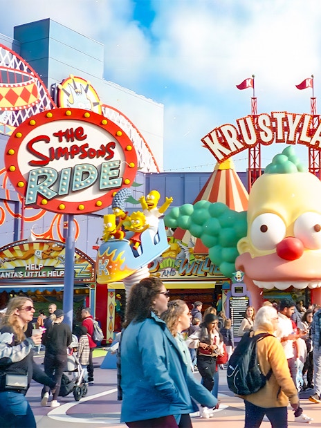 Krustyland entrance at Universal Studios Orlando with The Simpsons Ride sign and visitors.