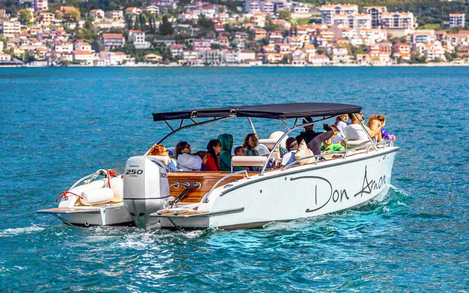 Speedboat with tourists on Bay of Kotor during Blue Cave tour.