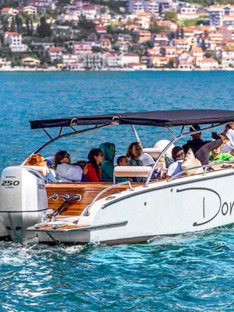 Speedboat with tourists on Bay of Kotor during Blue Cave tour.