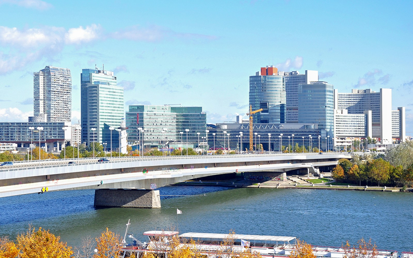 Reichsbrücke bridge over Danube River in Vienna, Austria with city skyline.