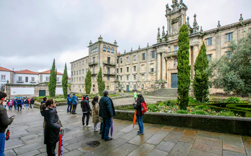 Visitors outside the Monastery of San Martiño Pinario, Santiago de Compostela, Spain.