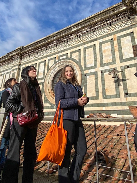 Visitors with a guide on the terrace of Florence Cathedral, Italy.