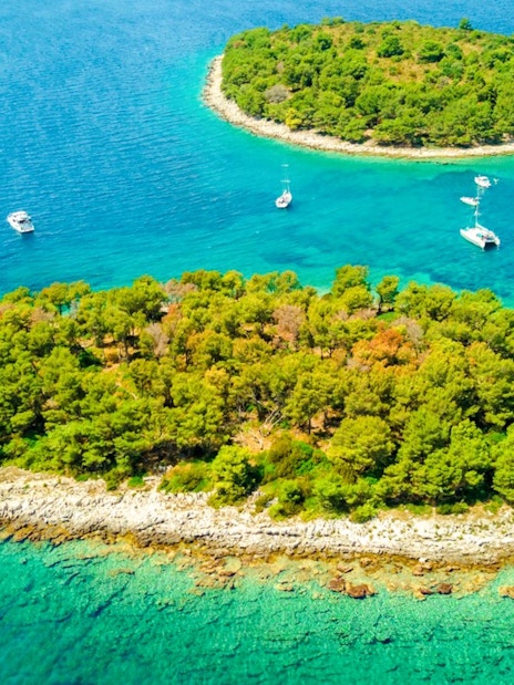 Aerial view of islands in the Blue Lagoon with boats in turquoise water.