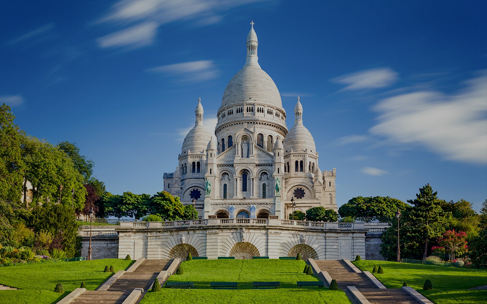 Montmartre street view with Sacré Coeur Basilica in the background during a guided tour in Paris.