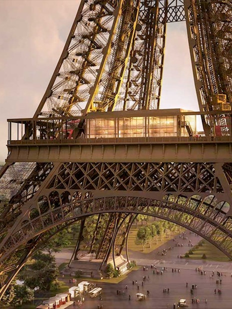 Eiffel Tower's Madame Brasserie exterior with Paris skyline in the background.