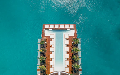 Floating pool deck at Yona Beach Club, Phuket, surrounded by turquoise water.
