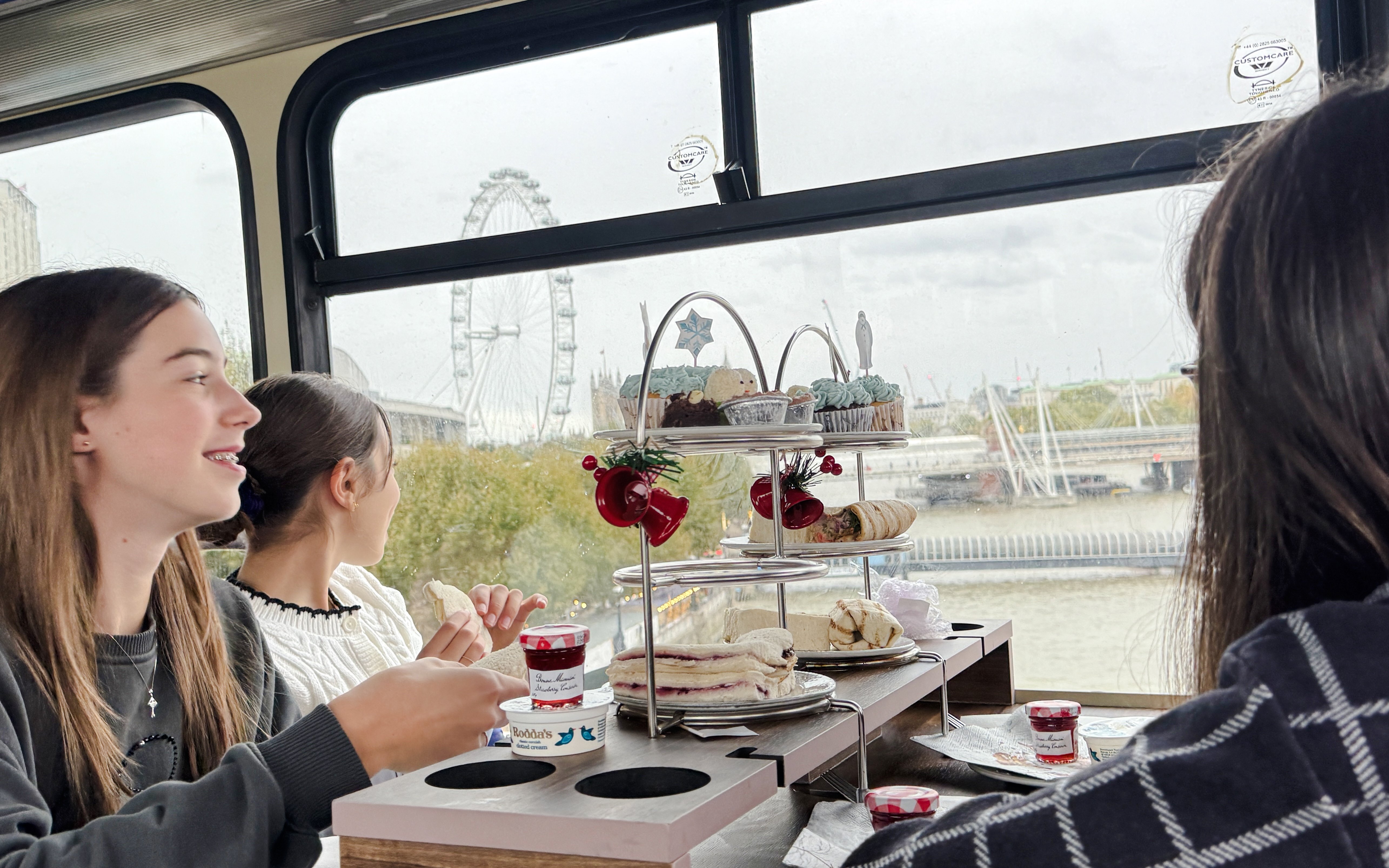 Afternoon tea on a bus with London Eye view during The Snowman™ tour.