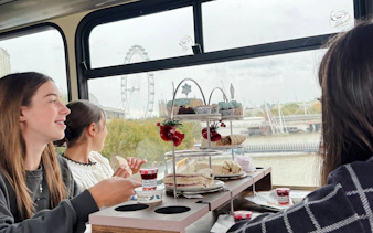 Afternoon tea on a bus with London Eye view during The Snowman™ tour.