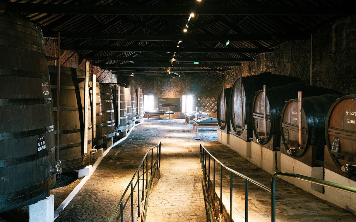 Fonseca port wine cellar with large wooden barrels in Porto, Portugal.