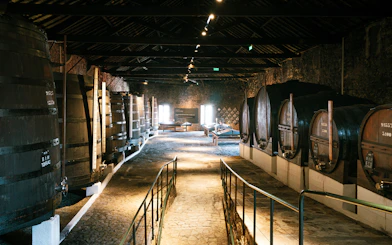 Fonseca port wine cellar with large wooden barrels in Porto, Portugal.
