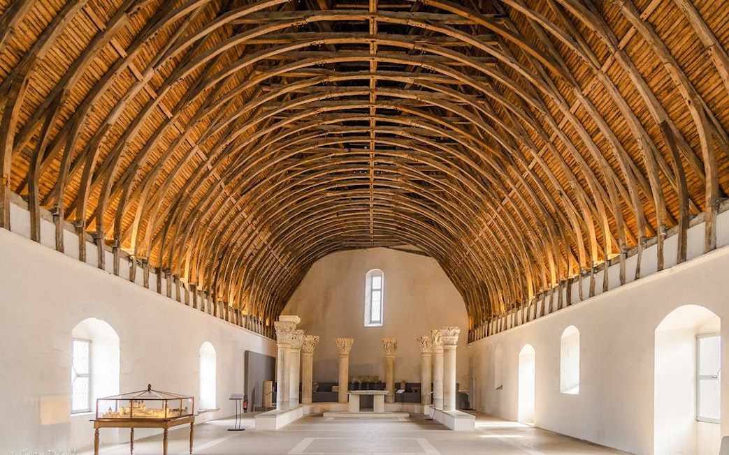 Interior of Cluny Abbey with vaulted wooden ceiling, Lyon, France.