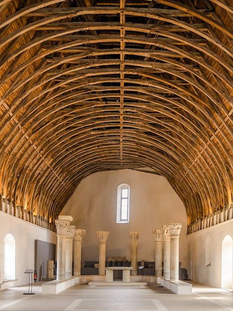 Interior of Cluny Abbey with vaulted wooden ceiling, Lyon, France.