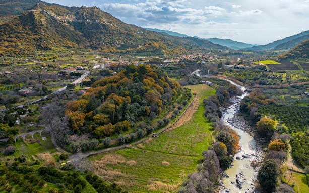 Aerial view of Valle Alcantara landscape with river and hills, ideal for Samurai 4x4 off-road adventure.