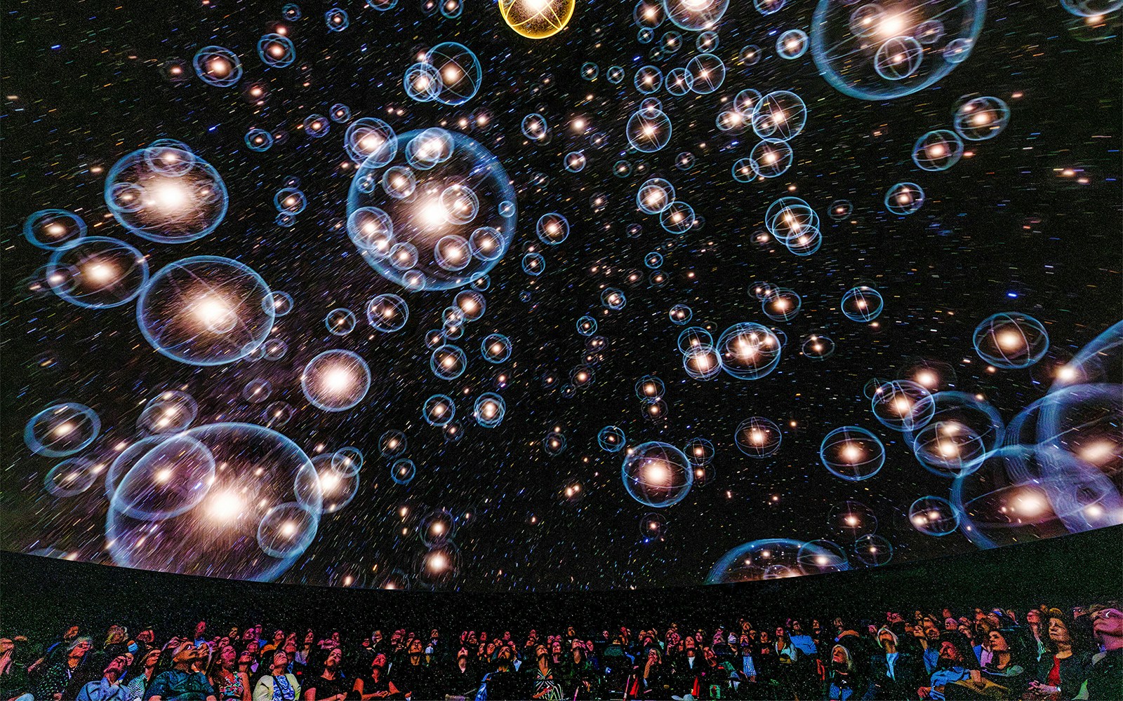 Visitors exploring the Encounters in the Milky Way exhibit at the American Museum of Natural History.