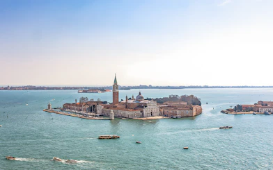 Aerial view of San Giorgio Maggiore Island in Venice, Italy, with boats in the lagoon.