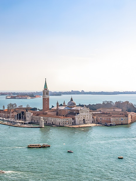 Aerial view of San Giorgio Maggiore Island in Venice, Italy, with boats in the lagoon.