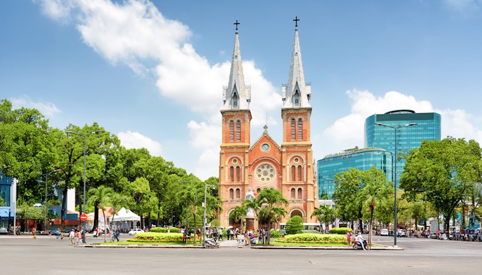 Saigon Notre-Dame Cathedral Basilica with bustling Ho Chi Minh City street scene.