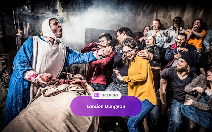 Visitors react to a live actor performance at The London Dungeon.